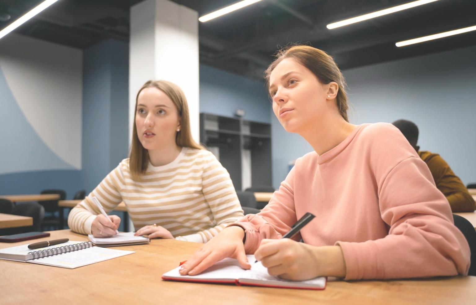Person reviewing budget spreadsheets and financial statements